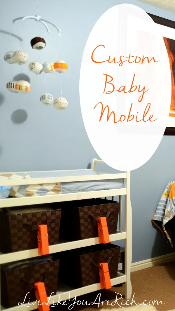 This Custom Baby Mobile is a great idea for decorating a nursery. They are often less expensive, match the decor better, and are fun to customize. I made this baby mobile for my son’s changing table a few years ago. This would be a great gift for a baby shower as well! #babymobile #nurseryroom #nurserydecor