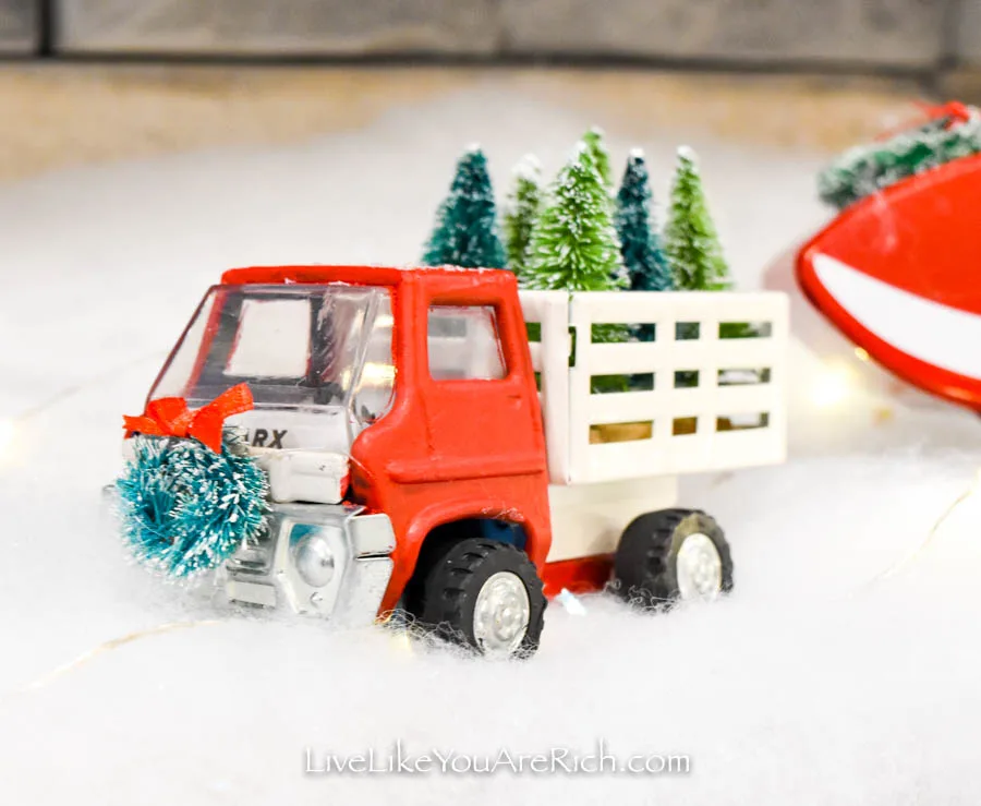 Restored red truck with mini Christmas trees