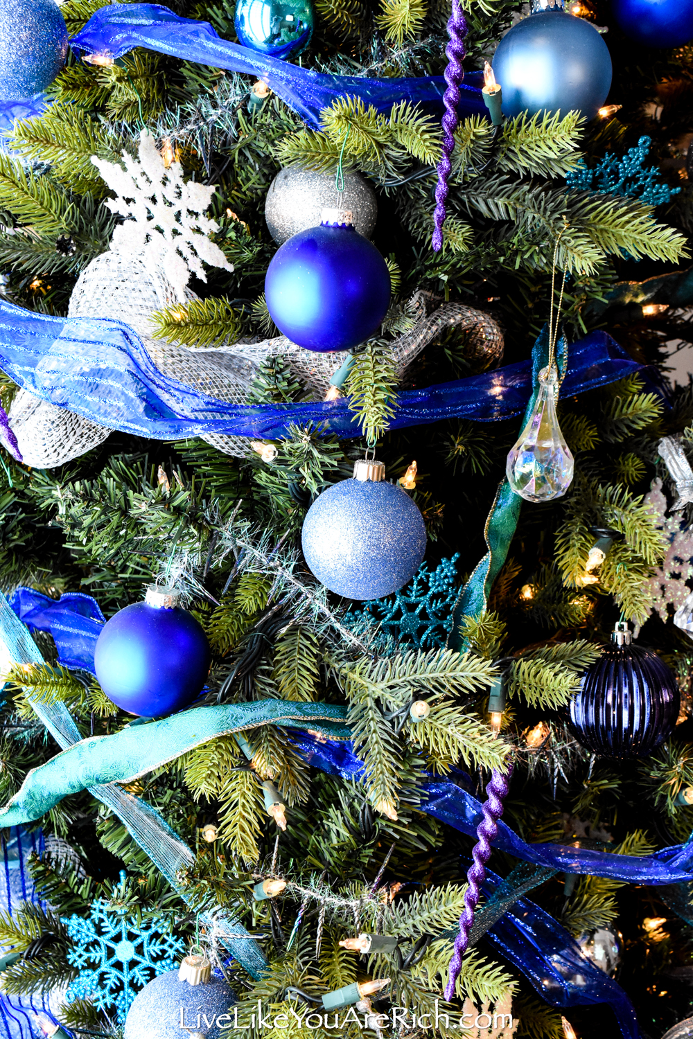 Christmas tree decorated with silver and white ribbons and